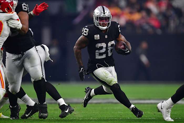 Las Vegas Raiders running back Josh Jacobs runs with the ball under his arm